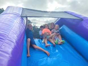 happy faces on party theme obstacle course hire 
